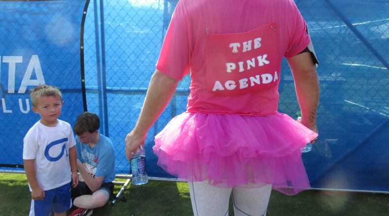 Richard Minor (right) shows off his pink tutu in support of the charity The Pink Agenda while son Pierce (left) looks on after the 2016 Atlanta Journal-Constitution Peachtree Road Race on July 4, 2016. PHOTO BY JORDAN D. HILL/JORDAN.HILL@AJC.COM