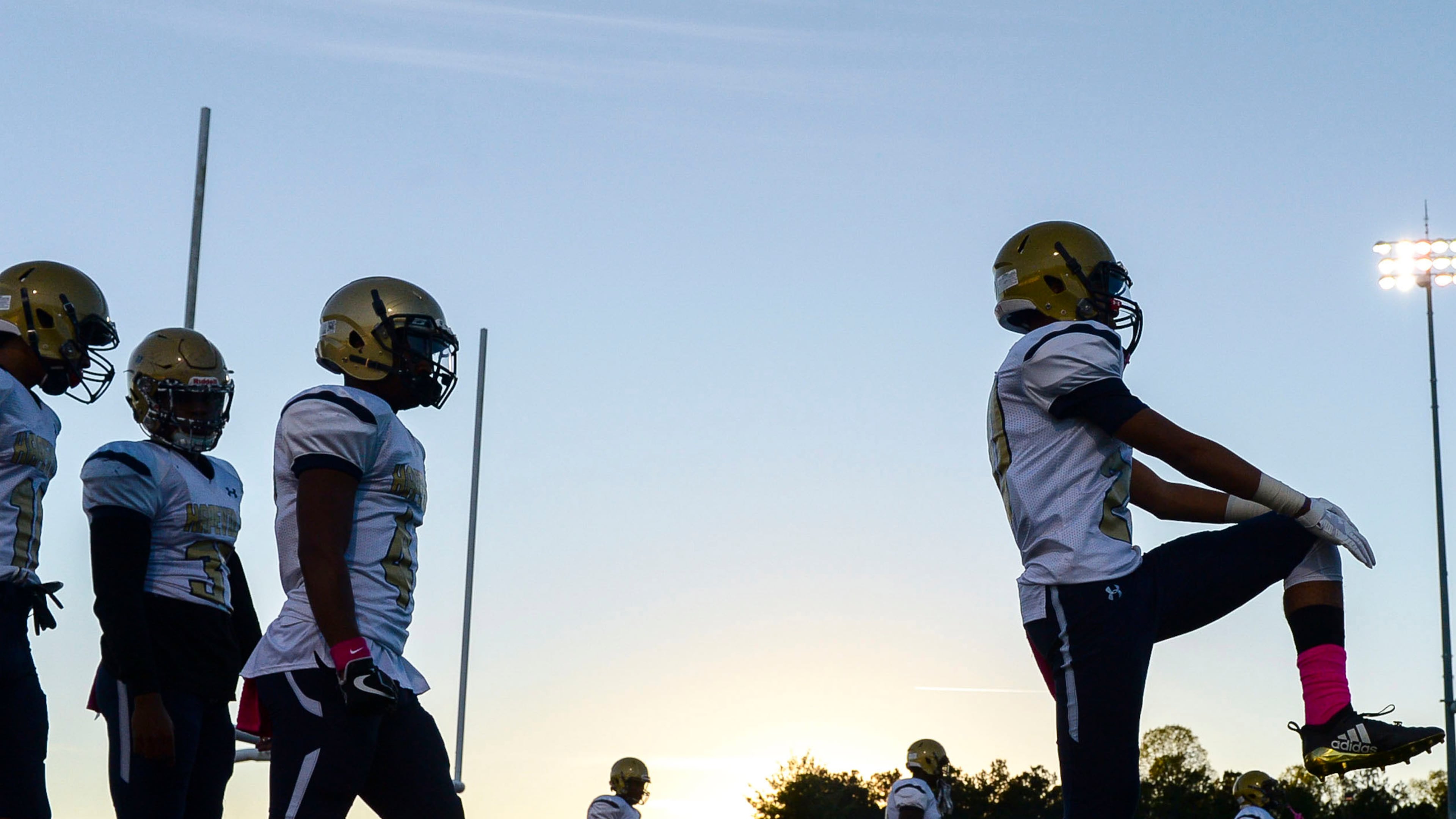 The Hapeville Charter Hornets run warmup drills prior to the start of their game Friday, October 12, 2018, at Allatoona High School.