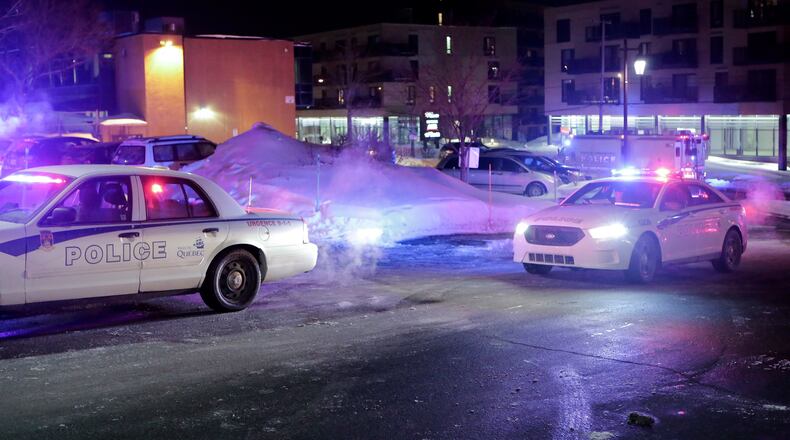 Police survey the scene after deadly shooting at a mosque in Quebec City, Canada, Sunday, Jan. 29, 2017. Quebec Premier Philippe Couillard termed the act "barbaric violence" and expressed solidarity with victims' families. (Francis Vachon/The Canadian Press via AP)