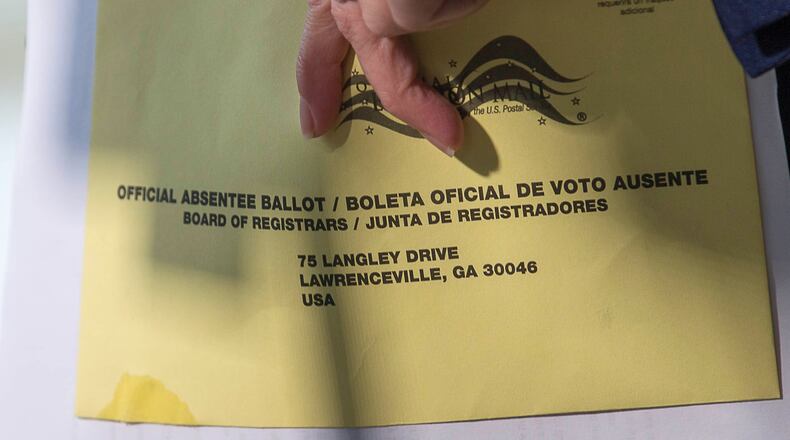 Carolyn Bourdeaux, Democratic Nominee for Georgia's 7th Congressional District, holds onto a Gwinnett County absentee ballot as she speaks during a press conference outside of the Gwinnett County Board of Voter Registration and Elections in Lawrenceville, Monday, November 12, 2018. Bourdeaux's campaign filed an emergency motion Sunday night seeking to force Gwinnett County to count previously rejected absentee ballots for the 2018 Midterm elections. (ALYSSA POINTER/ALYSSA.POINTER@AJC.COM)