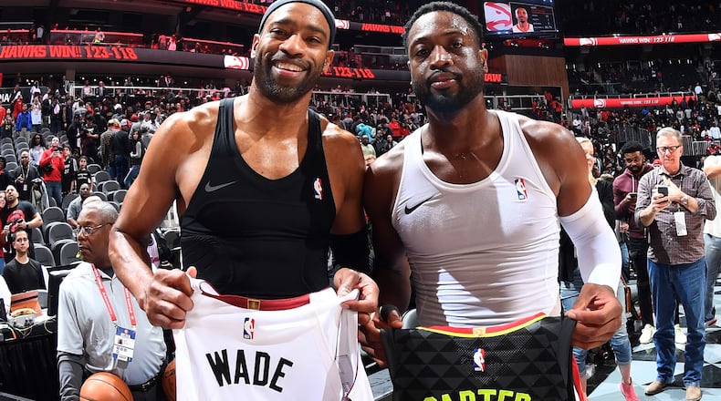The Hawks' Vince Carter (left) and the Heat's Dewayne Wade show off their jersey exchange following a game in Miami earlier this season. Photo by Scott Cunningham/Getty Images