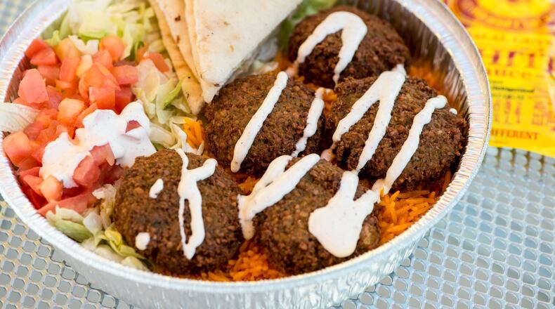 Falafel platter with rice, lettuce, tomato, grilled pita, and special white sauce from The Halal Guys. Photo credit- Mia Yakel.
