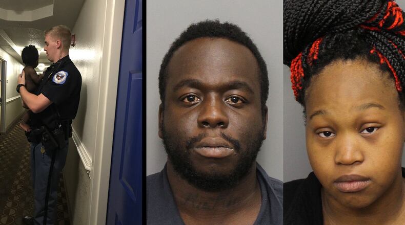 A Cobb County police officer holds a baby found in an apartment the department described on Facebook as so "deplorable" that it led to the arrests of Sanchez Lampkin and Tiffany Mathis (far right).