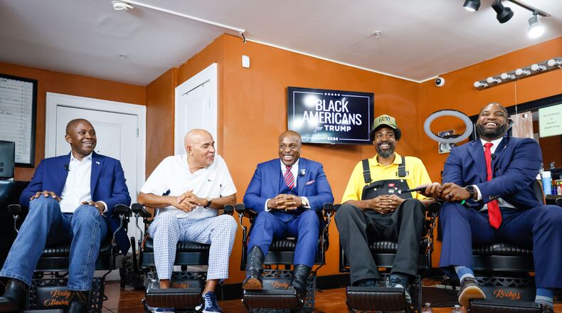 Black leaders and elected officials laugh as they chat with former President Donald by phone during a roundtable at Rocky’s Barbershop in Buckhead a day before the presidential debate on Wednesday, June 26, 2024.
(Miguel Martinez / AJC)