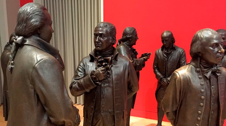 FILE - Life-size bronze sculptures of the signers of the U.S. Constitution stand in the Signers' Hall on July 7, 2016, at the National Constitution Center in Philadelphia. (AP Photo/Beth J. Harpaz, File)