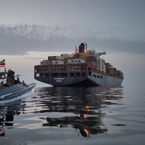 FILE - In this photo released by Tasnim News Agency, a Revolutionary Guard Navy (IRGC) speedboat approaches the cargo ship Epaminondas during what state media described as the seizure of one of two vessels accused of violations in the Strait of Hormuz, April 21, 2026. (Meysam Mirzadeh/Tasnim News Agency via AP, File)