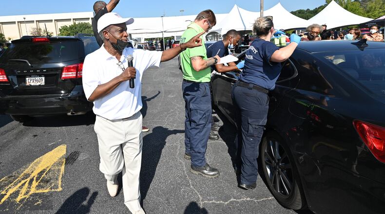 DeKalb County CEO Michael Thurmond encourages residents to get vaccinated during a vaccination event at The Gallery at South DeKalb in Decatur on Saturday, Aug. 13, 2021. The county gave out $100 prepaid debit cards to people who got shots. (Hyosub Shin / Hyosub.Shin@ajc.com)