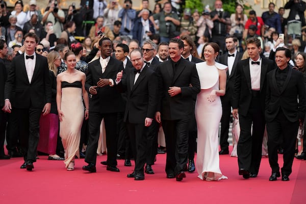 Cameron Mann, from left, Amelie Hoeferle, Micheal Ward, director Ari Aster, Joaquin Phoenix, Emma Stone, Austin Butler and Clifton Collins Jr. pose for photographers upon arrival at the premiere of the film 'Eddington' at the 78th international film festival, Cannes, southern France, Friday, May 16, 2025. (AP Photo/Natacha Pisarenko)
