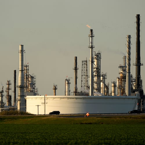 FILE - A motorist drives past the CHS oil refinery Sept. 28, 2024, in McPherson, Kan. (AP Photo/Charlie Riedel, File)