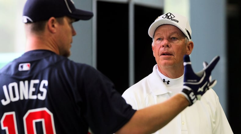 Chipper Jones (left) chats with his father, Larry Jones, during batting practice at the Braves' spring training facility