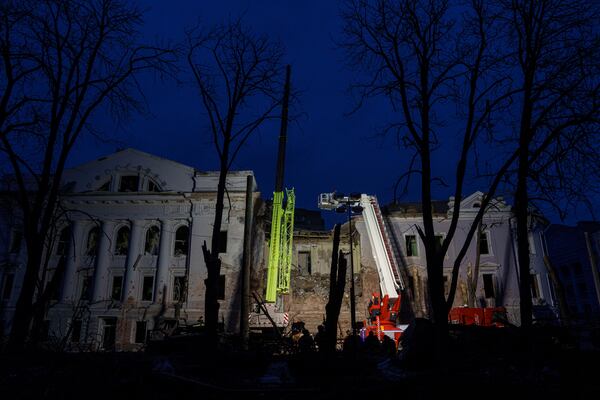 Rescue workers clear the rubble of a university building destroyed by a Russian missile strike on Sumy, Ukraine, Sunday, April 13, 2025. (AP Photo/Evgeniy Maloletka)