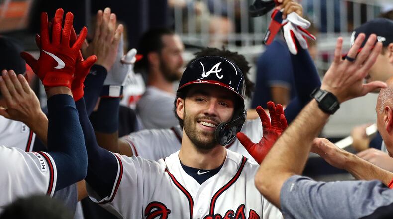 Braves' Dansby Swanson gets high fives in the dugout after hitting a 2-run home run. Curtis Compton/ccompton@ajc.com