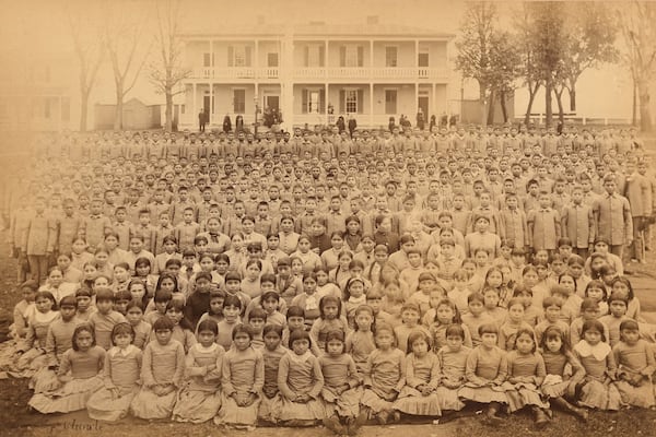 Carlisle Indian Industrial School students gather in front of the superintendent’s house in Carlisle, Pennsylvania, in 1885. (John N. Choate/Carlisle Indian School Digital Resource Center via AP)