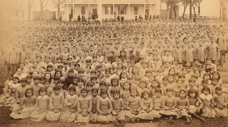 This photo provided by the Carlisle Indian School Digital Resource Center shows the Carlisle Indian Industrial School student body in front of the superintendent's house in Carlisle, Pa., circa 1885. (John N. Choate/Carlisle Indian School Digital Resource Center via AP)