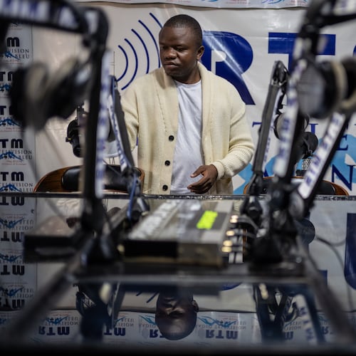 Verité Johnson works at a community radio station, providing daily awareness and updates on Ebola in Bunia, Congo, Thursday, June 4, 2026. (AP Photo/Moses Sawasawa)