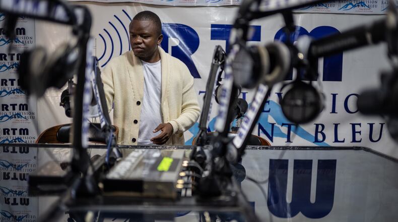 Verité Johnson works at a community radio station, providing daily awareness and updates on Ebola in Bunia, Congo, Thursday, June 4, 2026. (AP Photo/Moses Sawasawa)