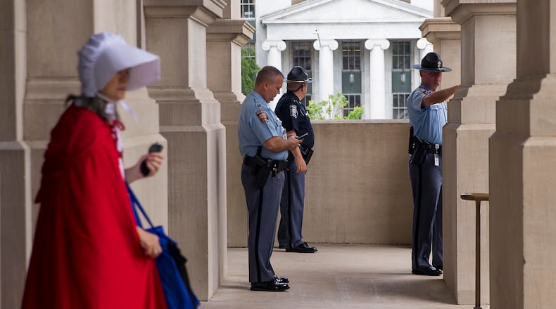 Georgia state troopers keep watch as a crowd of pro-choice protestors rally outside of the state Capitol after signing of HB 481 in Atlanta on Tuesday. (ALYSSA POINTER/ALYSSA.POINTER@AJC.COM)