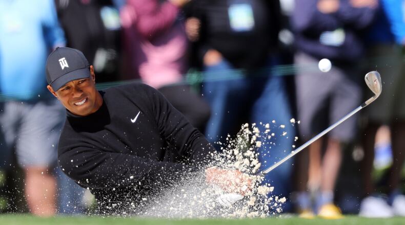 Tiger Woods, who found himself in a number hazards in his first Masters round since 2015, hits out of the  bunker on the second hole at Augusta National Thursday. Woods shot a 1-over-73 in the first round.