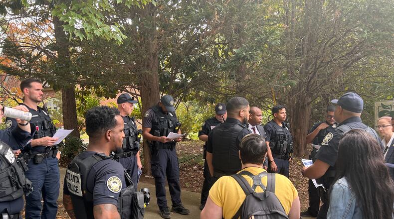 Several Atlanta police officers went door to door Wednesday asking residents if they had any information on the deaths of Dean Phillips and Ned Jackson, who were both shot Oct. 27, 2022.