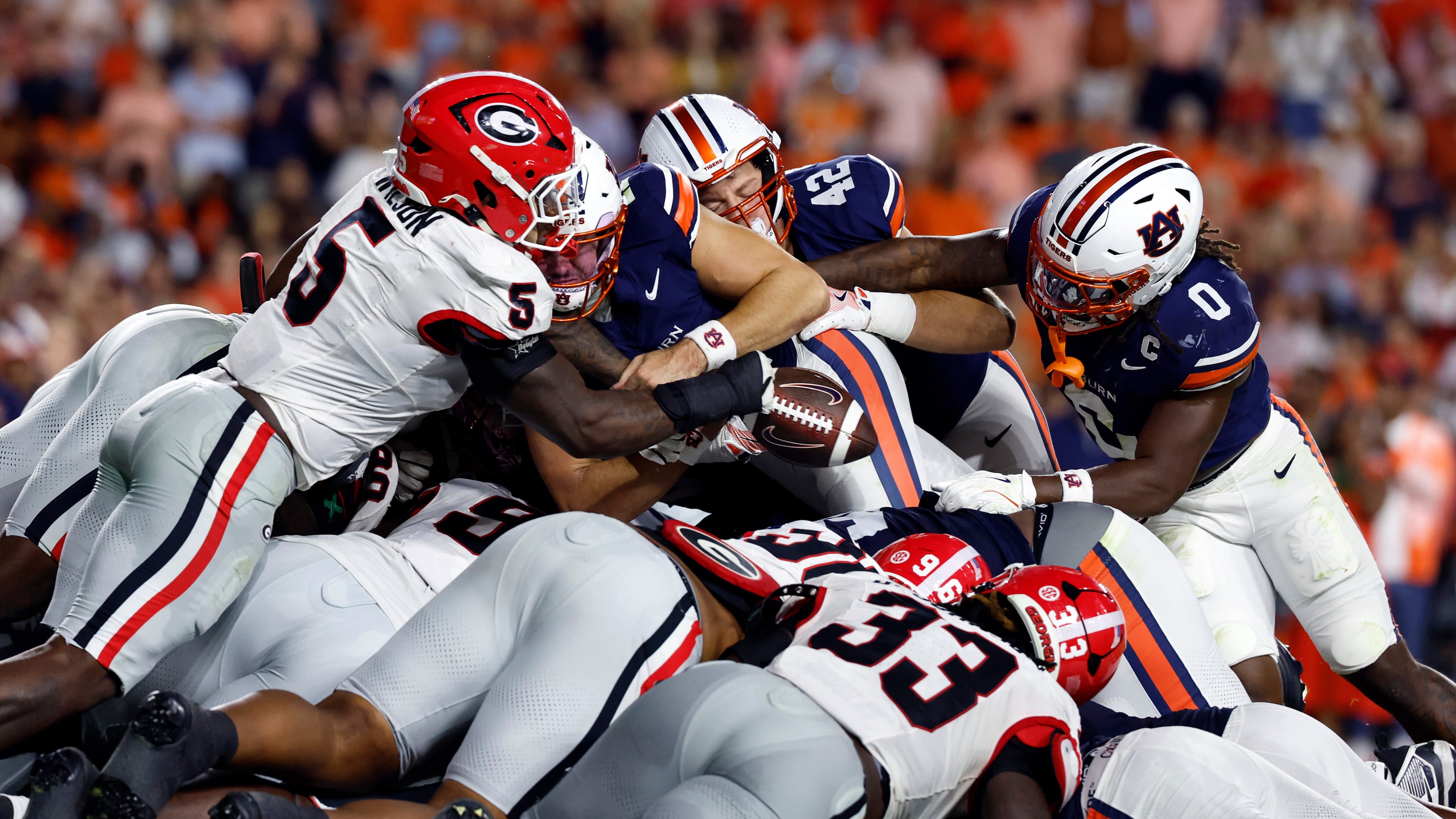 Georgia linebacker Raylen Wilson (5) knocks the ball out of the hands of Auburn quarterback Jackson Arnold (11) as he dives for the end zone during the first half of an NCAA college football game, Saturday, Oct. 11, 2025, in Auburn, Ala. (AP Photo/Butch Dill)