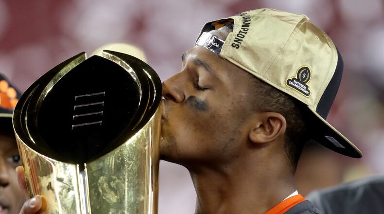 Quarterback Deshaun Watson of the Clemson Tigers celebrates with the College Football Playoff National Championship Trophy after defeating the Alabama Crimson Tide 35-31 to win the 2017 College Football Playoff National Championship Game in 2017. Local teachers will get a chance to snap a photo with the trophy Saturday, before the championship game comes to Atlanta.