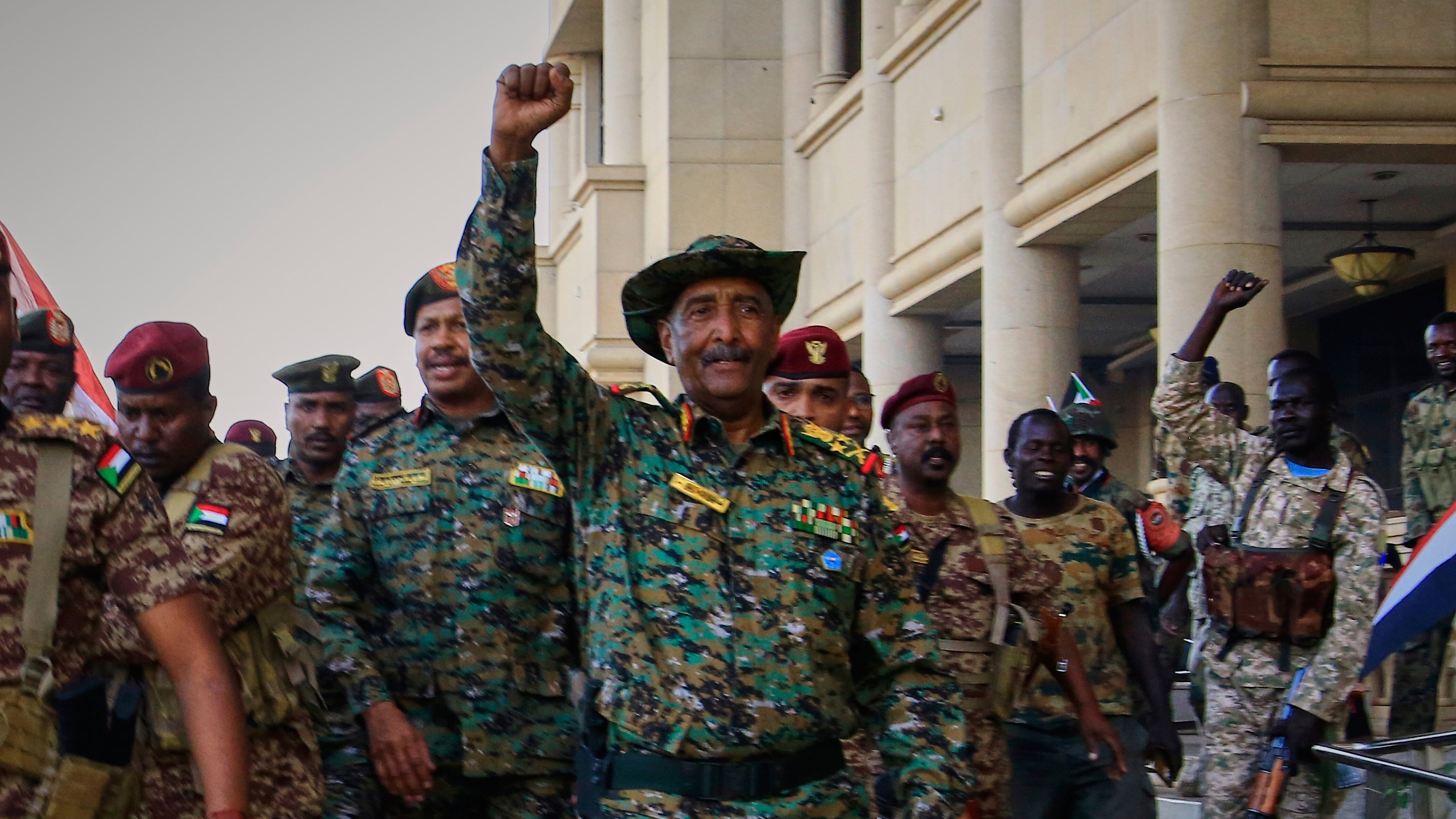 FILE - Sudan's military chief Gen. Abdel-Fattah Burhan, center, is greeted by troops as he arrives at the Republican Palace, recently recaptured from the Rapid Support Forces (RSF) paramilitary group, in Khartoum, Sudan, March 26, 2025. (AP Photo/File)
