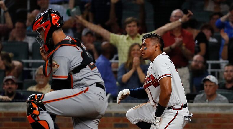 Johan Camargo of the Braves reacts after sliding safely past a mishandled catch by Buster Posey of the San Francisco Giants on a double hit by Ender Inciarte in the third inning at SunTrust Park on June 19, 2017 in Atlanta. (Photo by Kevin C. Cox/Getty Images)