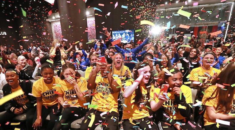 Confetti falls and the Chiefs of Cherokee (front) and five other girls football teams react as the Atlanta Falcons announce that in 2020 Georgia will become the fourth state to officially sanction girls high school flag football, during a rally before the Girls Flag Football Championship at Mercedes-Benz Stadium on Wednesday, Dec. 18, 2019, in Atlanta. CURTIS COMPTON/CCOMPTON@AJC.COM