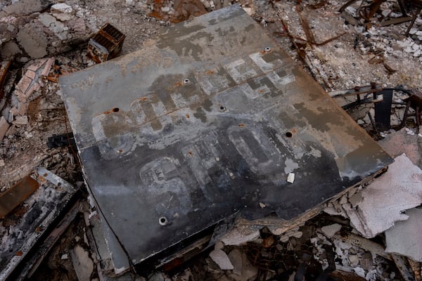 A sign for Little Red Hen Coffee Shop sits on the rubble after the business was destroyed by the Eaton Fire in Altadena, Calif., Friday, March 28, 2025. (AP Photo/Jae C. Hong)