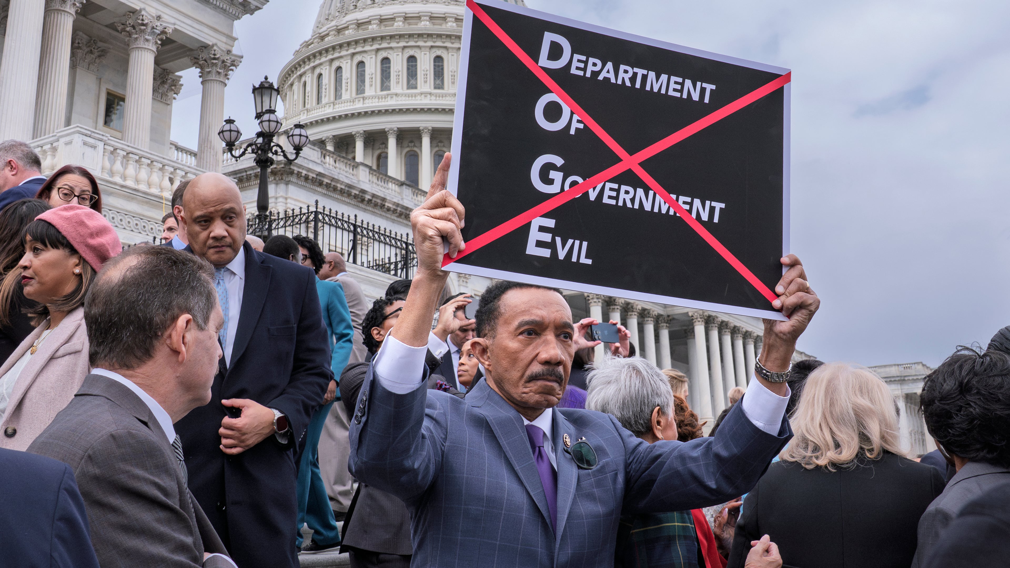 FILE - Rep. Kweisi Mfume, D-Md., protests against DOGE, the Department of Government Efficiency, as he and other House Democrats speak out against the Republican budget plan, on the House steps at the Capitol in Washington, Feb. 25, 2025. (AP Photo/J. Scott Applewhite, File)