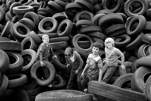The High Museum of Art hosts San Francisco photographer Mimi Plumb, discussing her first solo museum exhibition, “Blazing Light,” on Thursday, March 19. Pictured is “Boys and Tires, Sears Point” (1976). (Courtesy of the High Museum of Art/© Mimi Plumb)