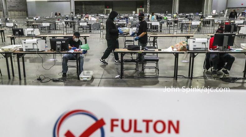 Fulton County elections workers open and sort ballots at the Georgia World Congress Center in Atlanta on Jan. 5, 2021. (AJC file photo)