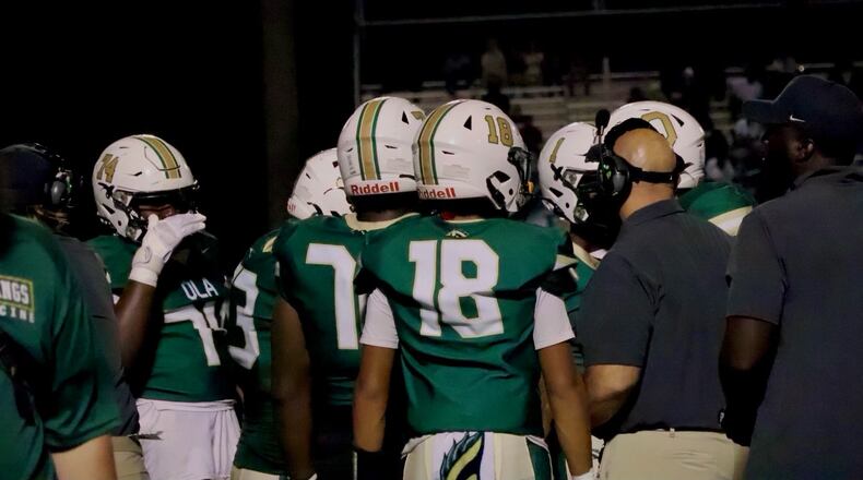 Ola coach Tom Causey talks to his offense during a timeout against Eastside. Ola won the game 42-14 on Sept. 15. (Photo Mattison Crump)