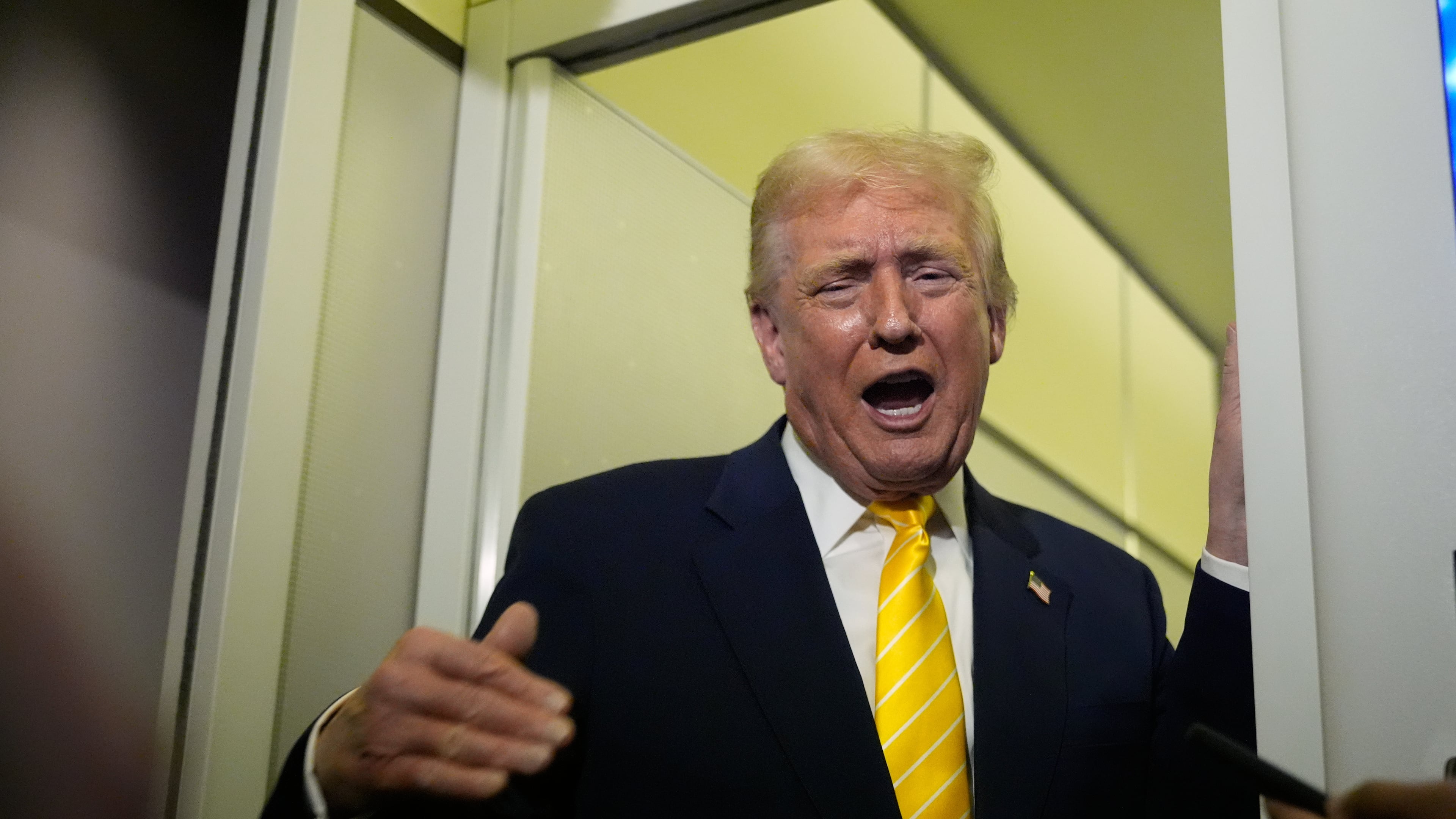 President Donald Trump speaks to reporters on Air Force One on his way to his Mar-a-Lago estate in Palm Beach, Fla., Friday, Nov. 14, 2025. (AP Photo/Manuel Balce Ceneta)