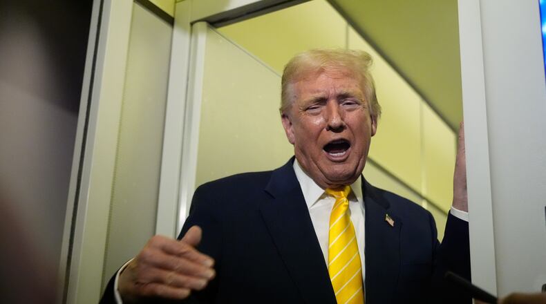 President Donald Trump speaks to reporters on Air Force One on his way to his Mar-a-Lago estate in Palm Beach, Fla., Friday, Nov. 14, 2025. (AP Photo/Manuel Balce Ceneta)