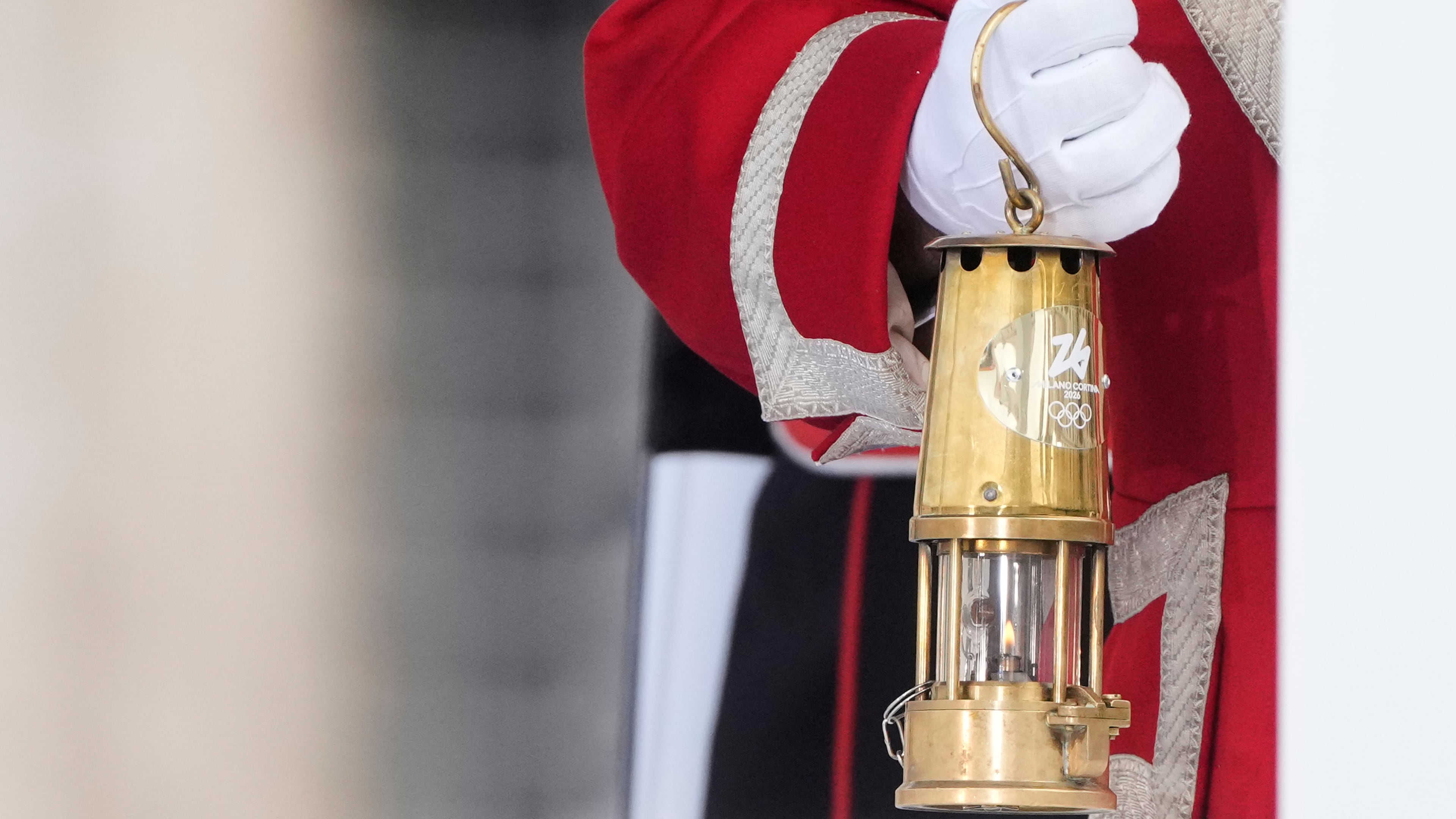 A cuirassier holds the torch lantern prior to the Milan Cortina 2026 Winter Olympics cauldron lighting, in front of the Quirinale Presidential Palace, in Rome, Friday Dec. 5, 2025. (AP Photo/Gregorio Borgia)
