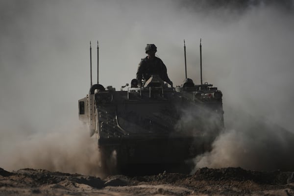 Israeli troops move with APC, armored personnel carrier near the border with Gaza, in southern Israel, Thursday, May 8, 2025. (AP Photo/Ariel Schalit)