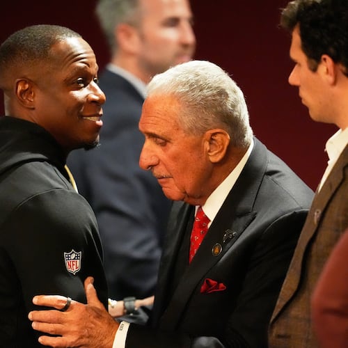 Atlanta Falcons owner Arthur Blank, right, hugs head coach Raheem Morris after an NFL football game against the New Orleans Saints, Sunday, Jan. 4, 2026, in Atlanta. (AP Photo/Mike Stewart)