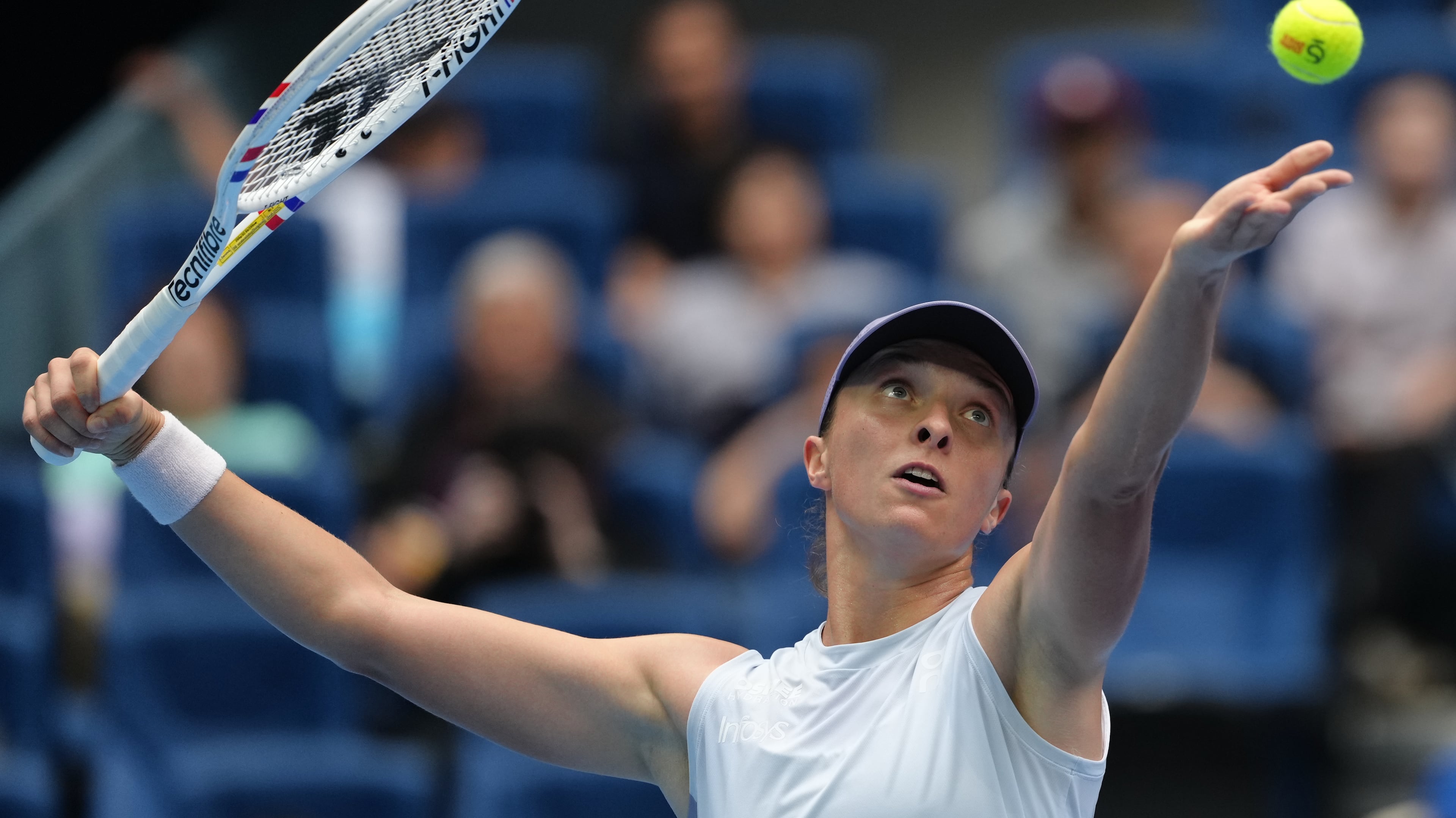 Iga Swiatek, of Poland tosses the ball to serve against Yuan Yue, of China during the women's singles match for the China Open tennis tournament, at the National Tennis Center, in Beijing, Saturday, Sept. 27, 2025. (AP Photo/Andy Wong)