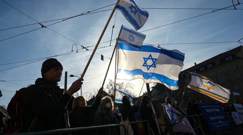Participants gather hold up Israeli flags during a demonstration in Leipzig, Germany, Saturday, Jan. 17, 2026. (Heiko Rebsch/dpa via AP)