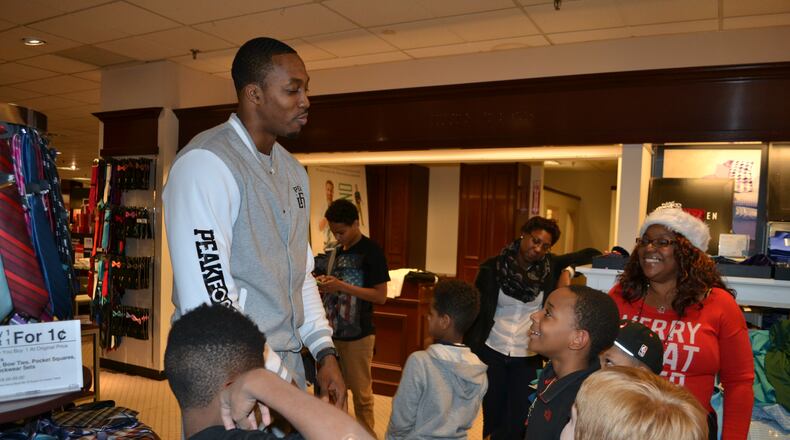 Dwight Howard speaks with kids from the Decatur YMCA after they complete a holiday shopping spree at JCPenney in Northlake Mall. COURTNEY MARTINEZ/COURTNEY.MARTINEZ@COXINC.COM