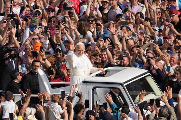Pope Leo XIV on his popemobile tours St. Peter's Square at the Vatican prior to the inaugural Mass of his pontificate, Sunday, May 18, 2025. (AP Photo/Domenico Stinellis)