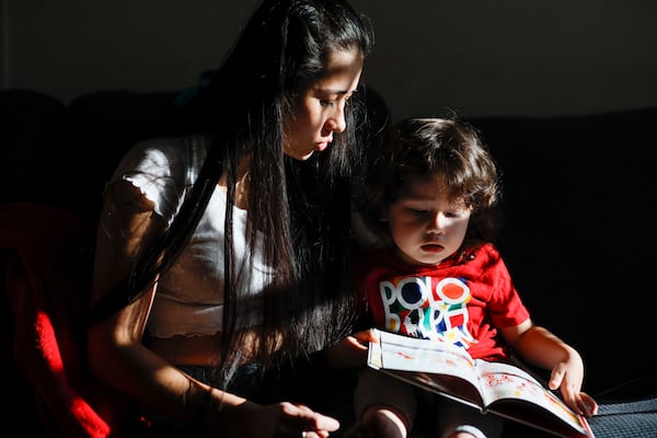 Ceudy Gutierrez reads a book to her 2-year-old son, Matias Gutierrez, at their home in Buford, GA, on Tuesday, Nov. 18, 2025. Ceudy Gutierrez is struggling to make ends meet for herself and her three young kids following her husband’s ICE arrest earlier this fall.
(Miguel Martinez/ AJC)
