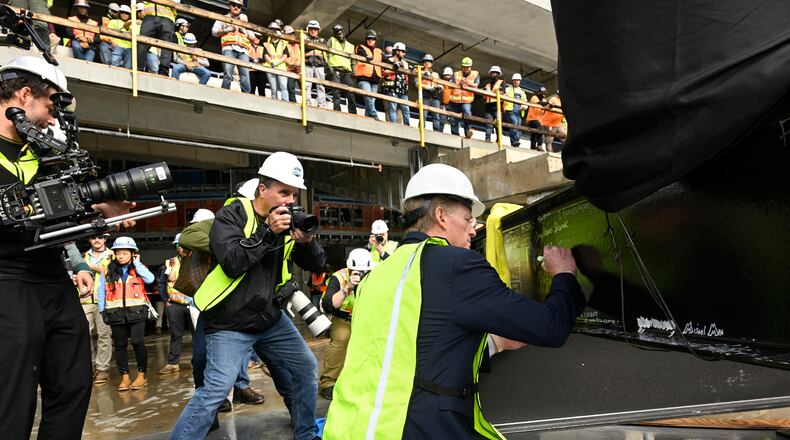 NFL Commissioner Roger Goodell signs a beam during a topping out ceremony to celebrate the ongoing construction of the Tennessee Titans NFL football new stadium, Friday, Nov. 21, 2025, in Nashville, Tenn. (AP Photo/John Amis)