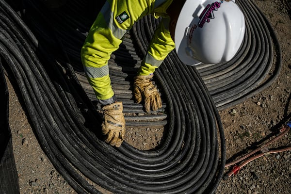 A worker lays cables at Energy Vault, a company that is creating an emergency power system that relies on hydrogen and battery storage, on Tuesday, May 27, 2025, in Calistoga, Calif. (AP Photo/Annika Hammerschlag)