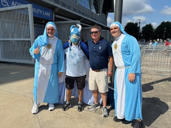 The two gents on the far left and right were a popular photo request from fans before Tuesday's Argentina-Egypt game at "Atlanta Stadium." They apparently have achieved a degree of fame for being Argentina's "nun fans." The one making the thumbs-up sign looks a little bit like an older Will Forte, the former Saturday Night Live cast member. (AJC photo by Ken Sugiura)