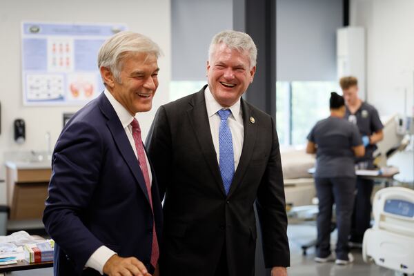 Medicare and Medicaid Services Administrator Dr. Mehmet Oz (left) and U.S. Rep. Mike Collins laugh together during a tour of the Piedmont University Nursing Facility in Athens on Sunday, Sept. 13, 2026. (Miguel Martinez/AJC)