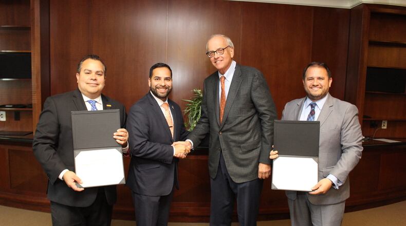 From left, Santiago Marquez (president and CEO) and Antonio Molina (chairman-elect) from the Georgia Hispanic Chamber of Commerce pose for a picture with the Gwinnett Chamber's Tom Andersen (board chair) and Nick Masino (president and CEO). COURTESY GWINNETT CHAMBER
