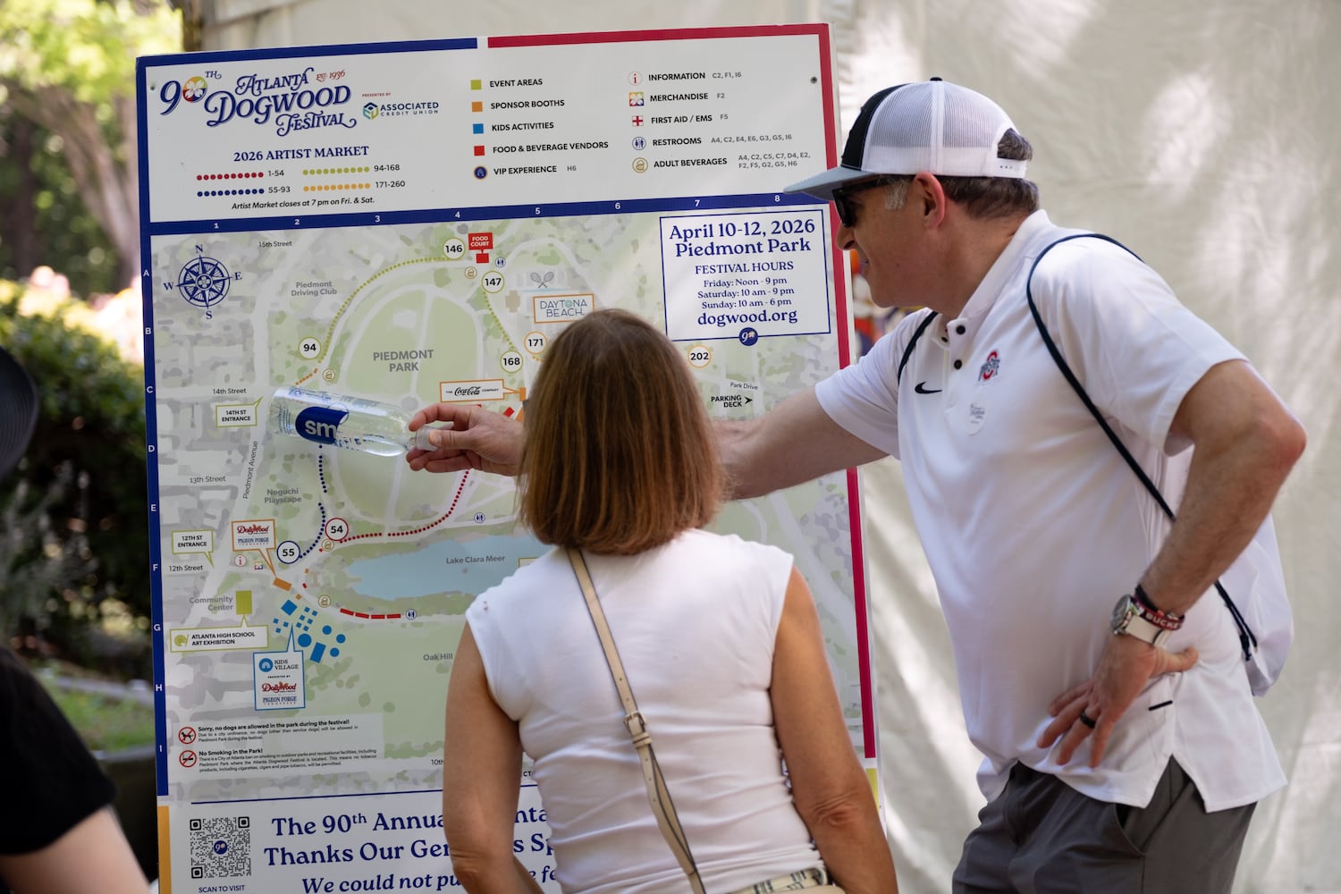 Neil and Donna Brodsky look at the map after arriving at the Atlanta Dogwood Festival at Piedmont Park on Saturday, April 11, 2026. (Ben Gray for the AJC)