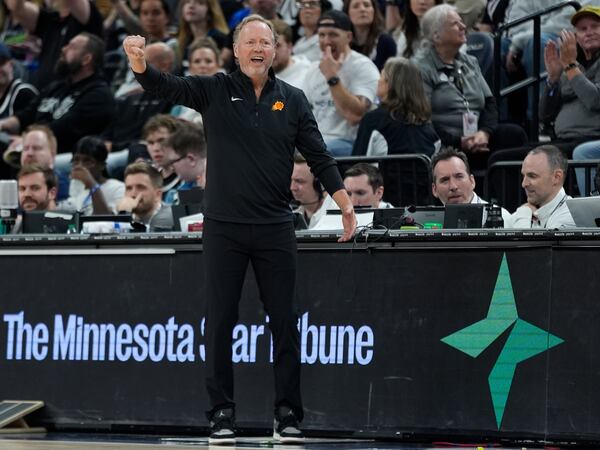 Phoenix Suns head coach Mike Budenholzer gestures during the second half of an NBA basketball game against the Minnesota Timberwolves, Friday, March 28, 2025, in Minneapolis. (AP Photo/Abbie Parr)